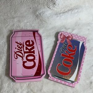 Diet Coke set up to notepads with metallic closure